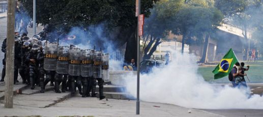 2471161_riot-police-chase-demonstrators-near-the-maracana-stadium-in-rio-de-janeiro