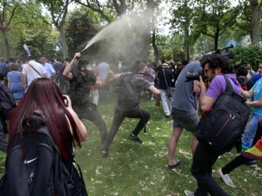 A Turkish riot policeman uses tear gas as people protest in Taksim Square in central&nbsp;Istanbul_0