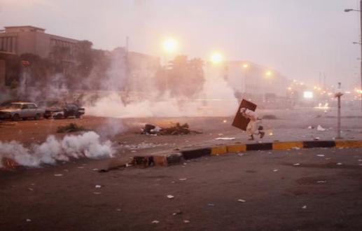 A supporter of deposed President Mursi runs from tear gas thrown at pro-Mursi protesters by police during during clashes in Nasr&nbsp;city