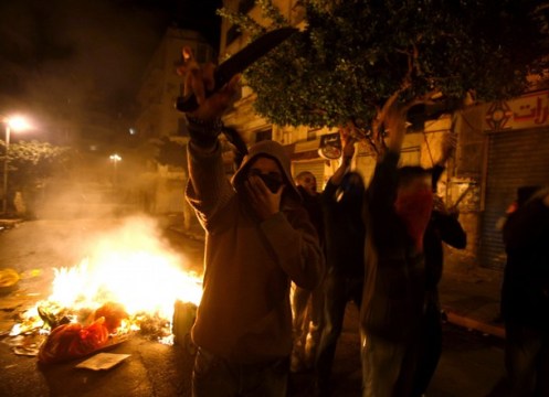 Algerian protesters hold knives during clashes with police in Bab el-Oued district of Algiers