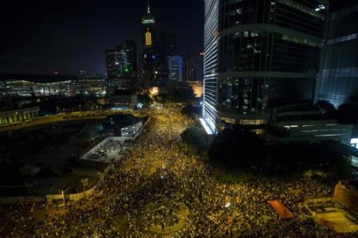 Thousands of protesters attend a rally outside the government headquarters in Hong Kong as riot police stand&nbsp;guard