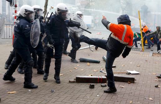 Demonstrators confront riot police during clashes in central&nbsp;Brussels