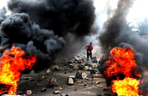 778067-a-protester-sets-up-a-barricade-during-a-protest-against-burundi-s-president-pierre-nkurunziza-and-h